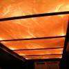 Стеклянный потолок с оранжевой подсветкой